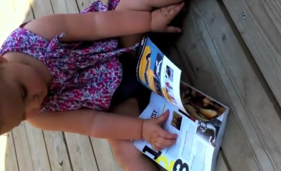 This baby tried to use a glossy magazine like an iPad, and failed