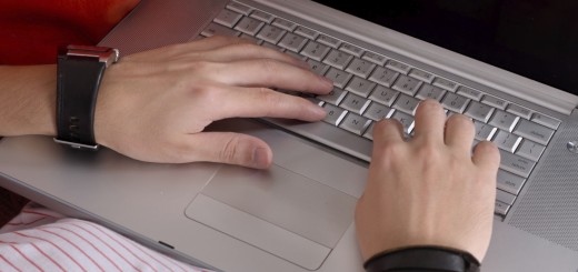 Closeup Casual Man's Hands on Laptop's Keyboard