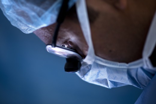 A member of the surgical team looks down