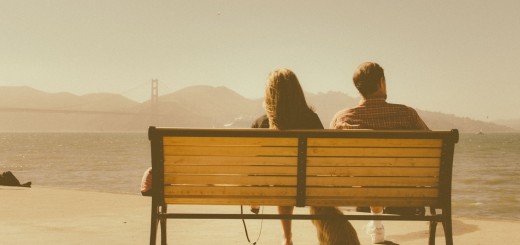 couple sitting by bridge