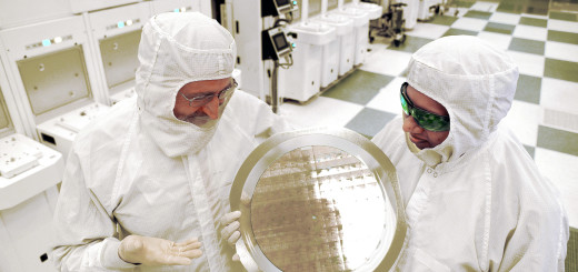 SUNY College of Nanoscale Science and Engineering's Michael Liehr, left, and IBM's Bala Haranand look at wafer comprised of 7nm chips on Thursday, July 2, 2015, in a NFX clean room Albany.   Several 7nm chips at SUNY Poly CNSE on Thursday in Albany.  (Darryl Bautista/Feature Photo Service for IBM)
