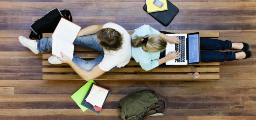 Top view of male and female university students studying